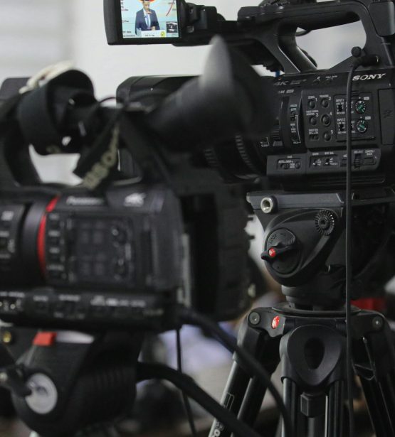 Close-up of professional video cameras set for filming indoors.